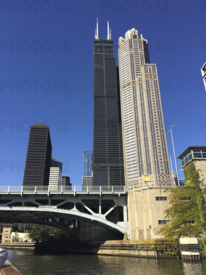 Skyscraper next to a bridge over a river in a modern urban environment, chicago, illinois, usa