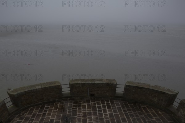 Mont-Saint-Michel, monastery mountain, view from the Tour Cholet into the mudflats in foggy weather