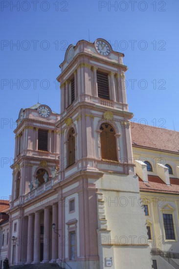 Baroque church with striking pink towers and blue sky, wachaus, donau, austria