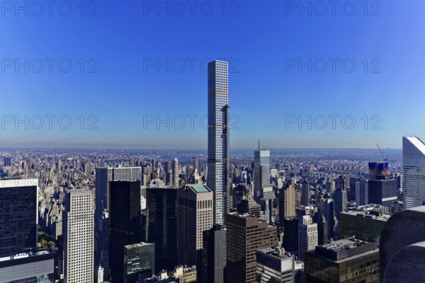 Rockefeller Center observation deck, Modern skyscrapers towering under a bright blue sky above the