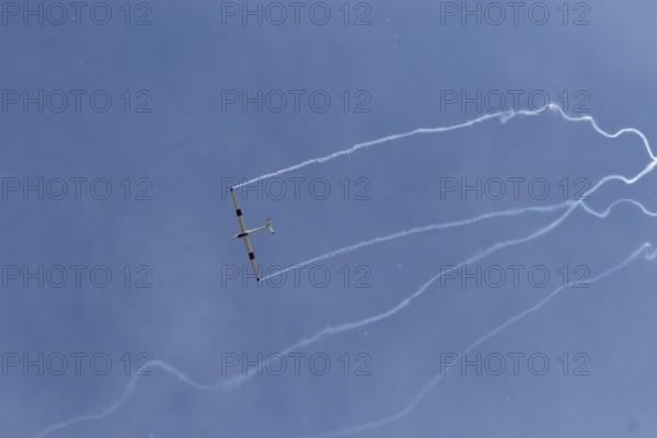 Airshow, glider with contrails against blue sky, Montreal, Province of Quebec, Canada, North