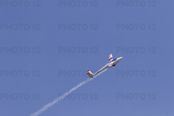 Airshow, glider with contrails against blue sky, Montreal, Province of Quebec, Canada, North
