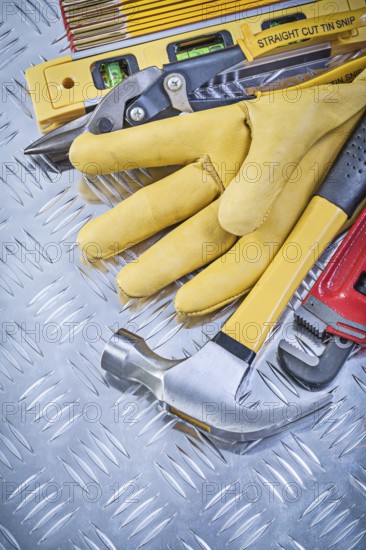Composition of claw hammer leather safety gloves construction level wooden meter pliers pipe wrench