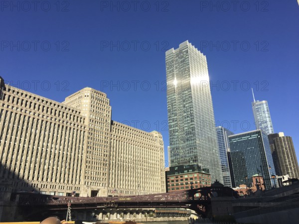 Skyline of a city with modern and historic buildings under a blue sky, chicago, usa