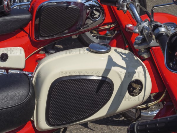 Detailed view of a red motorbike with white fuel tank and leather accents, Appelhülsen,