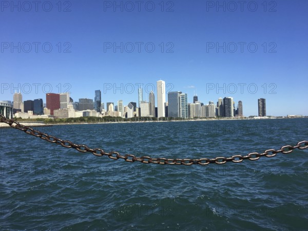 View across the sea to the coastline with a chain in the foreground, chicago, illinois, usa