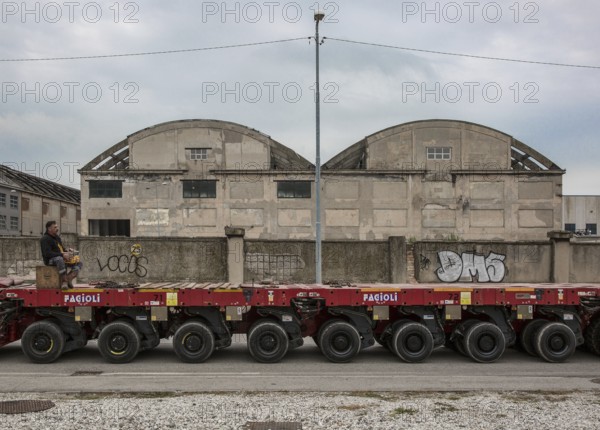Porto Marghera near Venice, industrial harbour, warehouse with low loader