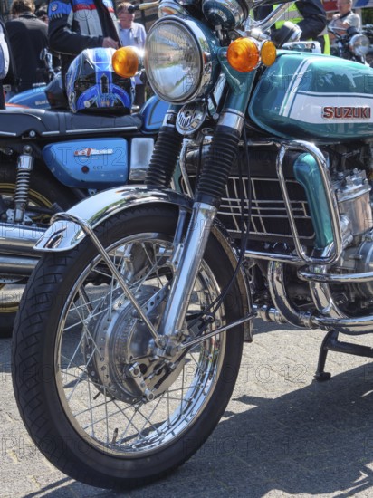 Retro Suzuki motorbike with silver and chrome-coloured elements on the road, Appelhülsen,
