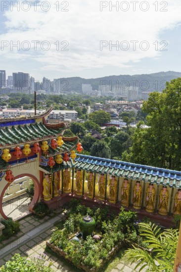 Overview of a colourful temple garden with city in the background, penang, malaysia