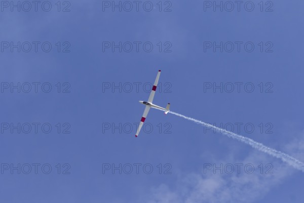 Airshow, glider with contrails against blue sky, Montreal, Province of Quebec, Canada, North