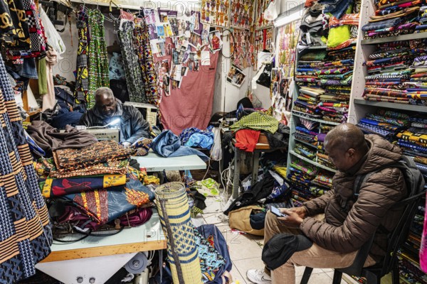 Tailor, black man, African fabrics, Noailles, oriental neighbourhood in Marseille, France, Europe