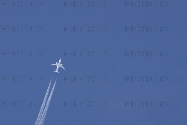 Boeing 787-8 Dreamliner jet passenger aircraft of Aeromexico flying in a blue sky with a vapor