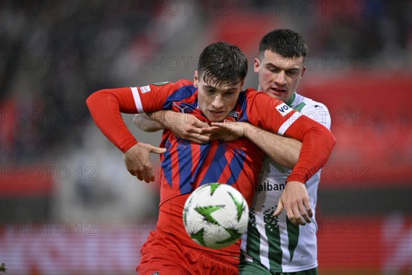tackle, action Jozo Stanic FC St. Gallen (04) v Luca Kerber 1. FC Heidenheim 1846 FCH (20) holding