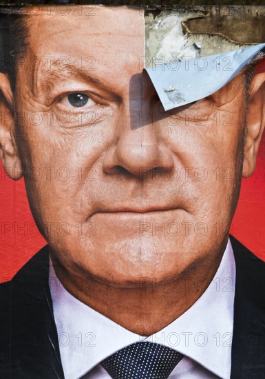 Partially destroyed large poster for the 2025 federal election by the SPD with Olaf Scholz, Witten,