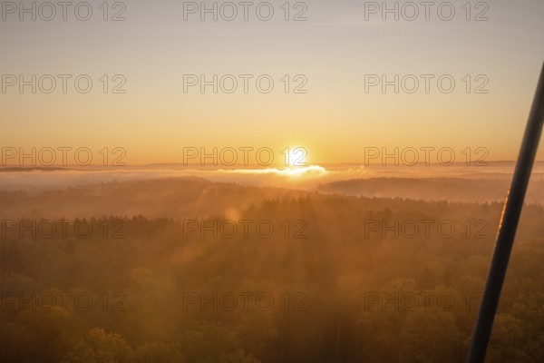 The sun rises over misty forests, bathing the landscape in warm light, Herrenberg, Schönbuchturm,
