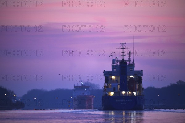 Ships, tanker, cargo ship meet at sunrise in the Kiel Canal, NOK, Kiel Canal, Schleswig-Holstein,