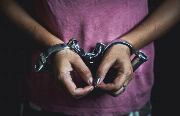 Woman hands in handcuffs- concept image