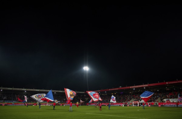 Night shot, flag waving, flags, flags in front of the start of a Bundesliga match, Voith-Arena,
