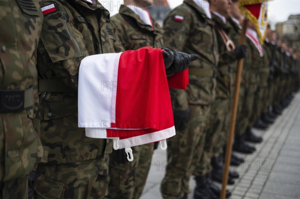 The Polish flag held by a soldier during the ceremony. Poland