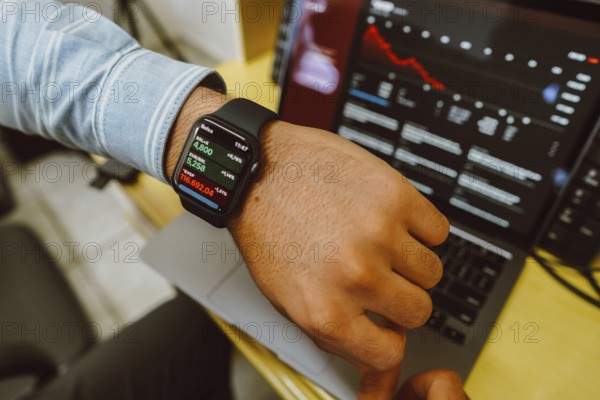 In this photo, man checking the stock price on the stock exchange through his Apple Watch