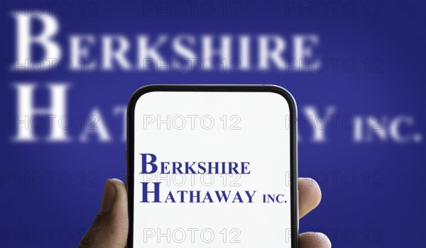 Berkshire Hathaway inc logo is displayed on smartphone. Berkshire Hathaway Inc is an American
