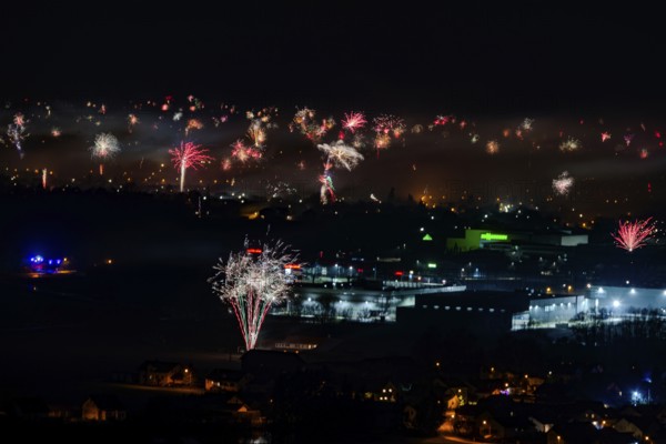 Large firework explosions light up the evening scenery of the city, Straubing, Lower Bavaria