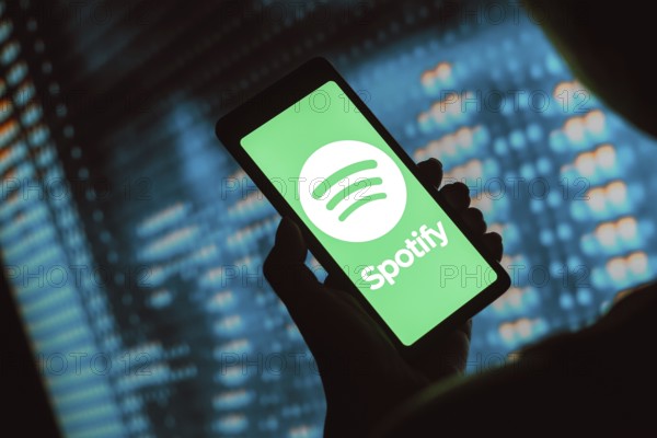 In this photo illustration, the Spotify Technology logo is displayed on a smartphone screen