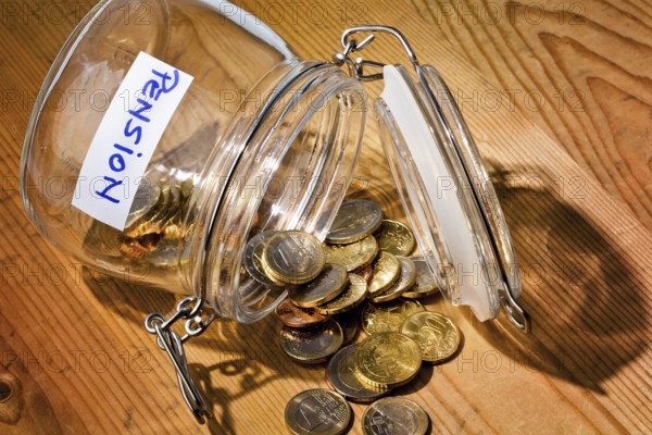 Pieces of money in a jam jar. Provision for old age is becoming less and less. Poverty in