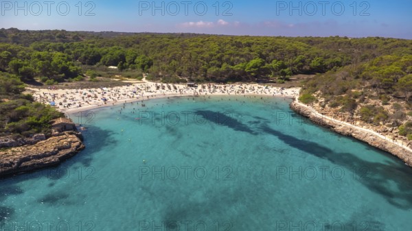 Aerial view capturing tourists enjoying the crystal clear turquoise waters at cala s'amarador and