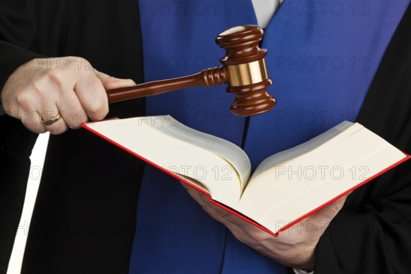 A judge with a law book in court. Gavel in hand, A judge with a law book in court. Gavel in hand.