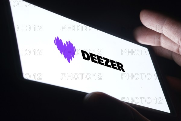 deezer logo is displayed on smartphone. Deezer is a French music streaming service