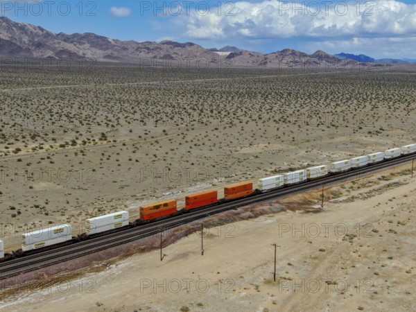 Cargo locomotive railroad engine crossing Arizona desert wilderness. Freight train passing by the