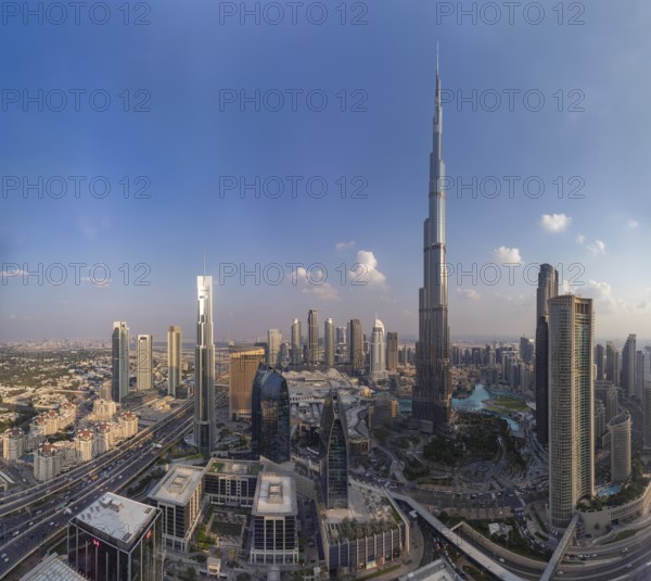 A picture of the Burj Khalifa towering the buildings of the nearby Downtown Dubai, Business Bay and