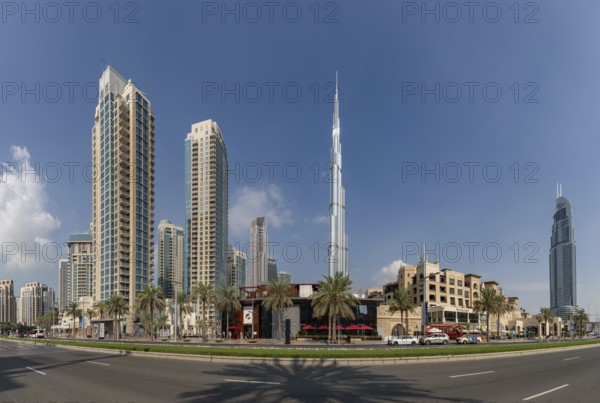 A picture of the Burj Khalifa towering nearby Downtown Dubai buildings