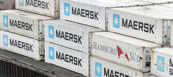 Large group of sea cargo freight containers Maersk and Hamburg Süd stacked on pier in container