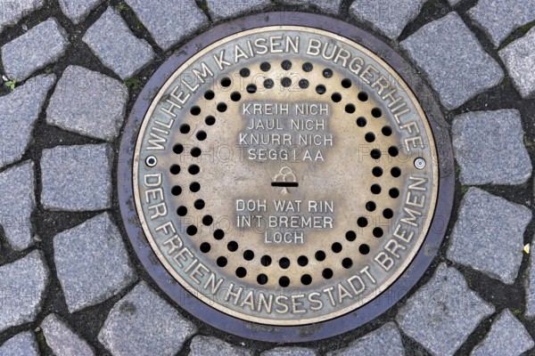 Gully cover Bremer Loch on cobbled market square with singing of Bremen Town Musicians, Old Town
