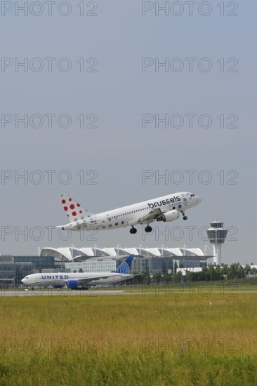 Brussels Airlines A319 taking off on Runway North with United Airlines, control tower and Terminal