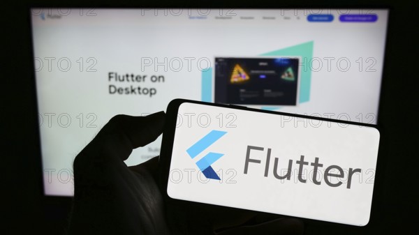 Stuttgart, Germany, 07-09-2023: Person holding cellphone with logo of UI software development kit