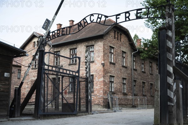 The main gate to the concentration camp Auschwitz Birkenau with an inscription in German Arbeit
