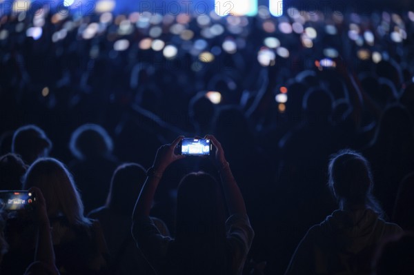 Crowd of people in front of the stage during the concert.
