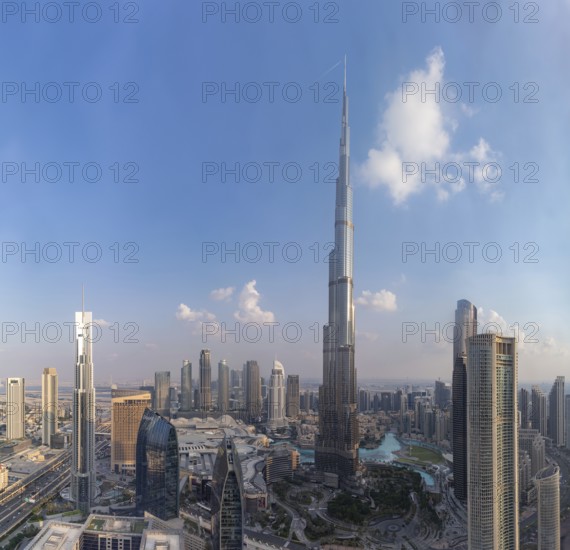 A picture of the Burj Khalifa towering the buildings of the nearby Downtown Dubai, Business Bay and