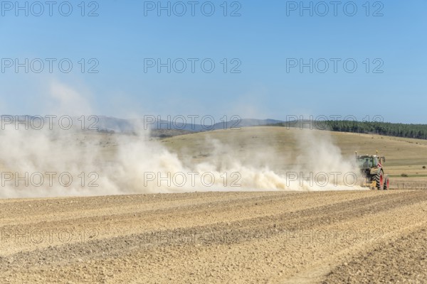 Dust cloud lifted by tractor in times of drought. Cevennes, massif central, France, Europe