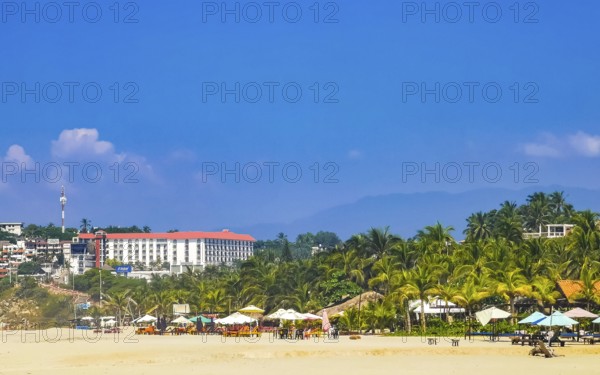 Sun beach people waves and boats in Zicatela Puerto Escondido Oaxaca Mexico