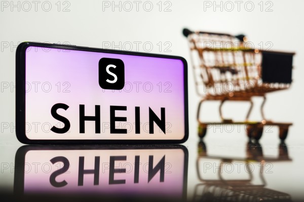 In this photo illustration, the Shein logo seen displayed on a smartphone along with a shopping