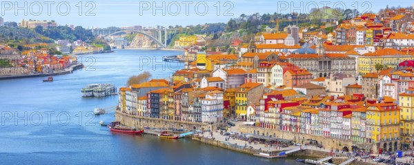 Porto, Portugal old town ribeira aerial promenade view with colorful houses, Douro river and boats