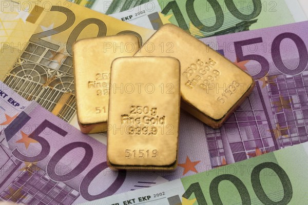 Investment in real gold with gold bars and euro banknotes, 250 gram gold bar studio recording,
