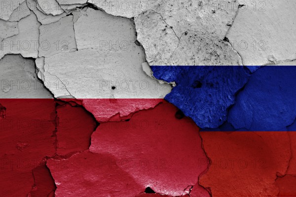Flags of Poland and Russia painted on cracked wall