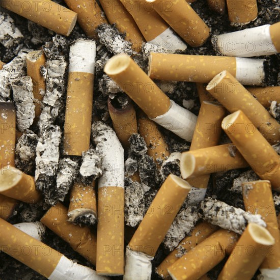 Cigarettes texture, busy ashtray square still shot