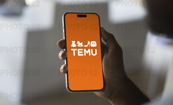 Temu logo online marketplace ecommerce on a smartphone and computer in Stuttgart, Germany.
