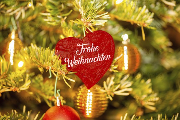 Christmas greetings: Heart with the inscription FROHE WEIHNACHTEN on a Christmas tree